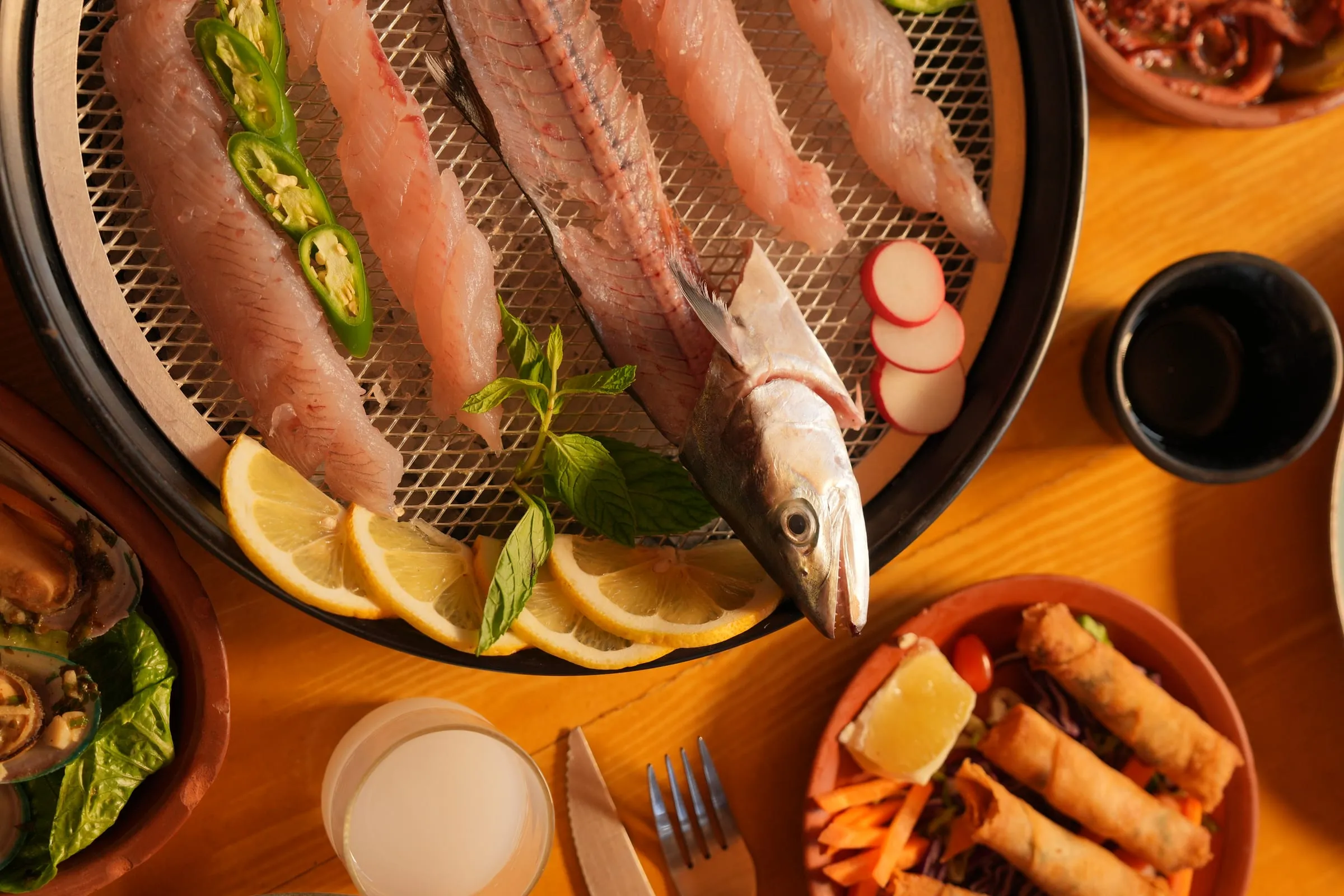 The day's whole fish on the charcoal grill rack with lemon, radish and herbs at Oyster's Seafood Bar, Batroun