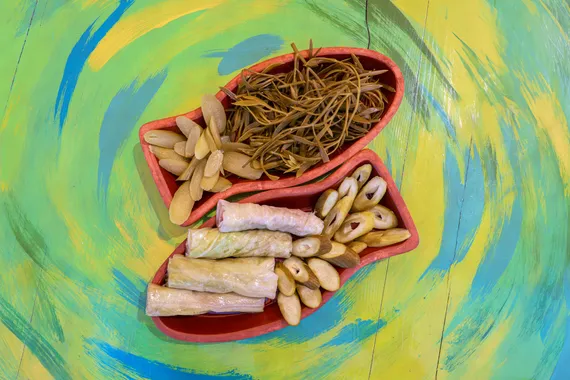 Small fried fish and sea fennel on a painted green table at Oyster's Seafood Bar, Batroun